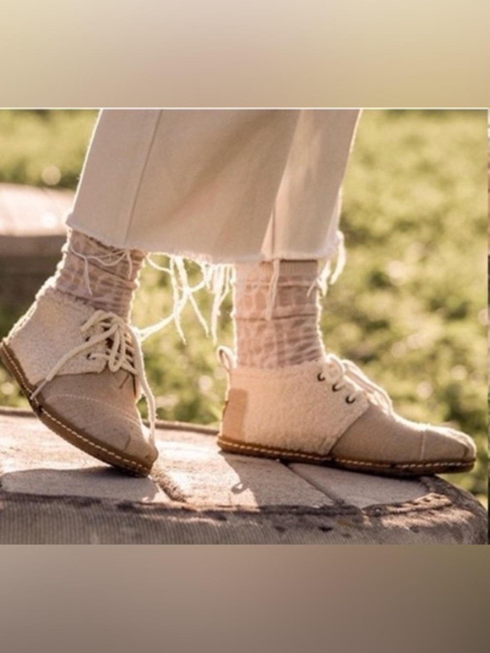 TOMS lace-up booties feature a soft white faux-shearling and metallic accent